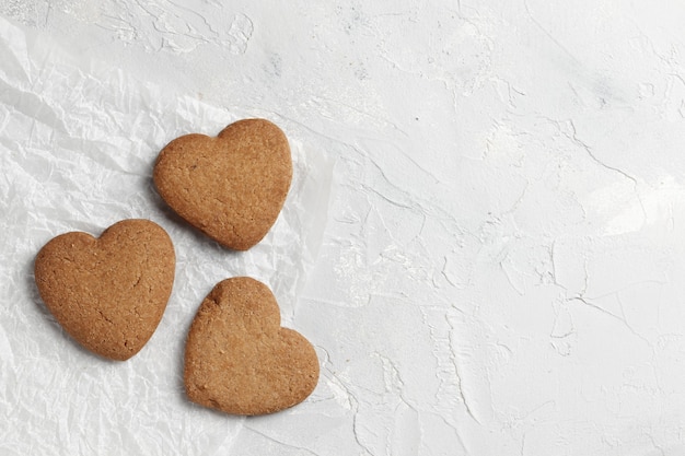 Delicious homemade cookie hearts  on a light background. Top view. Place for text.