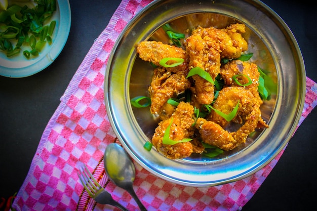 Delicious homemade crispy fried chicken with spicy taste and lemon on plate