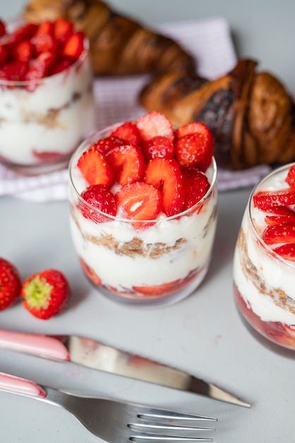 delicious homemade dessert with cream and strawberries in a glass