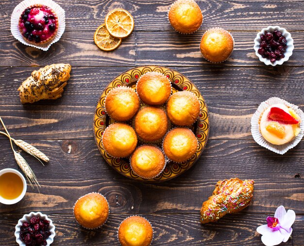 Delicious homemade muffins with yogurt, on a wooden surface with space for text.