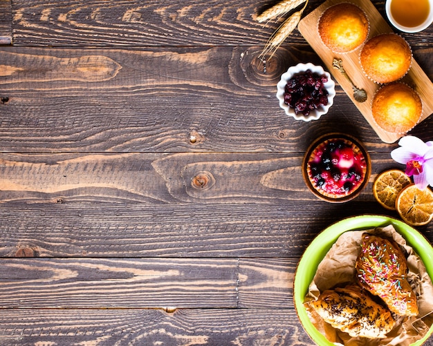 Delicious homemade muffins with yogurt, on a wooden surface with space for text.