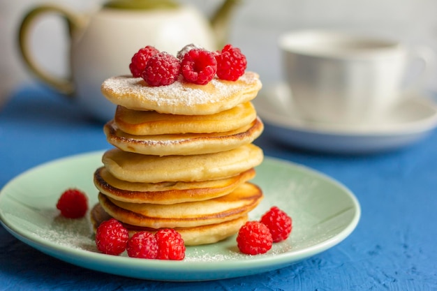 Delicious homemade pancakes with raspberries on a plate.Delicious homemade breakfast.