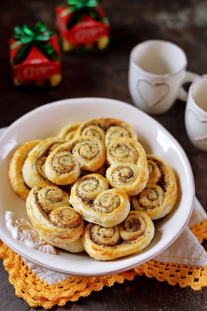 Delicious homemade puff pastry cookies with sugar, cinnamon and poppy seeds