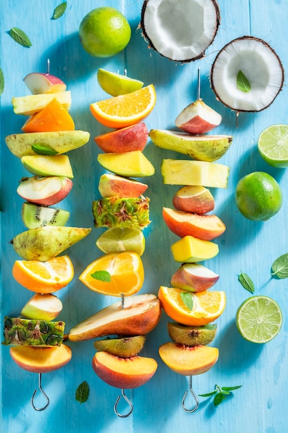 Delicious and homemade skewers with many exotic fruits for party