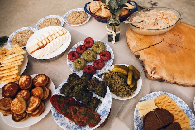 Delicious homemade sweets and snacks served on a round table outside 