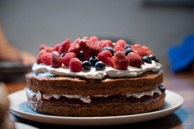 Delicious homemade vegan cake topped and decorated with cream and berry fruits