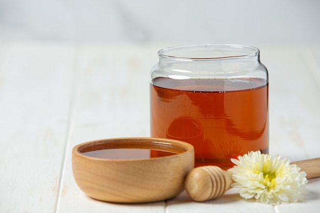 Delicious honey on white wooden surface