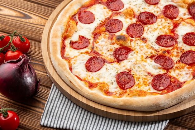 Delicious hot homemade Pepperoni pizza on the wooden table.