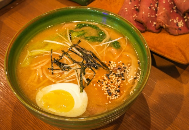 Delicious hot warming japanese ramen noodles soup in a bowl on the table