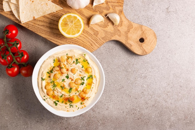 Delicious hummus with chickpeas olive oil lemon and pita bread Vegetarian food concept