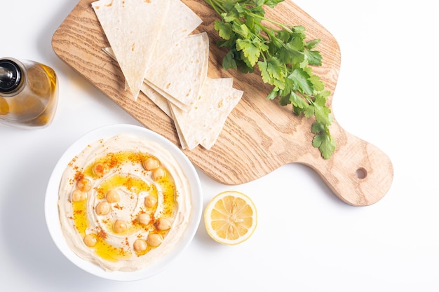 Delicious hummus with chickpeas olive oil lemon and pita bread Vegetarian food concept