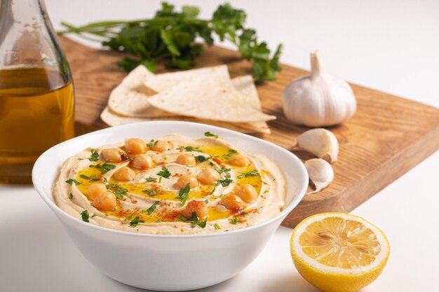 Delicious hummus with chickpeas, olive oil, lemon and pita bread. Vegetarian food concept.