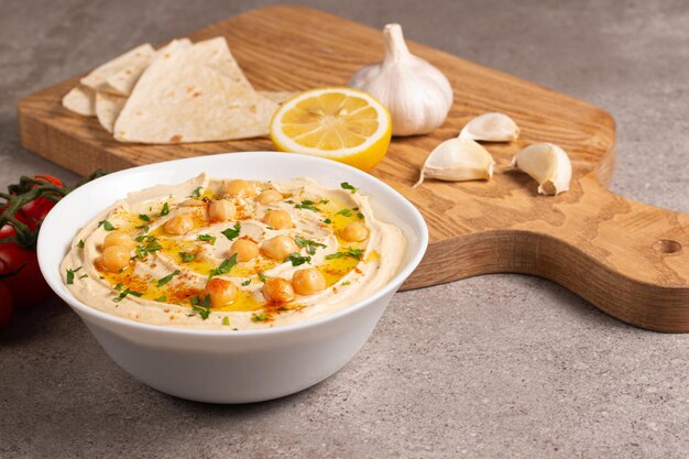 Delicious hummus with chickpeas, olive oil, lemon and pita bread. Vegetarian food concept.