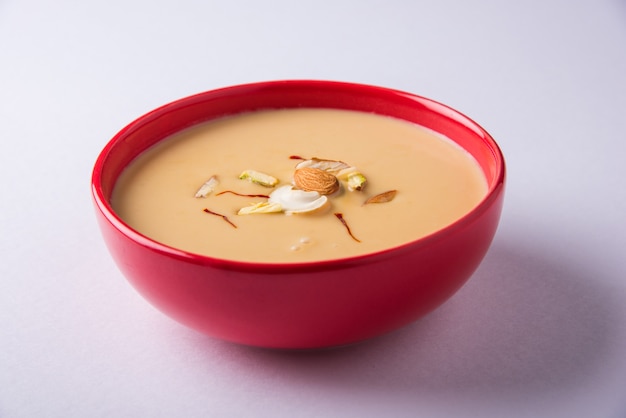 Delicious indian sweet rabdi or rabri with dry fruits toppings.\
popular festival food tests great with jalebi/jilbi. served in a\
bowl over colourful or wooden table top. selective focus