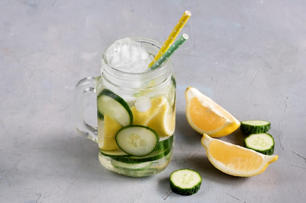 Delicious infused water with cucumber lemon in glass bottle for fat flush detox