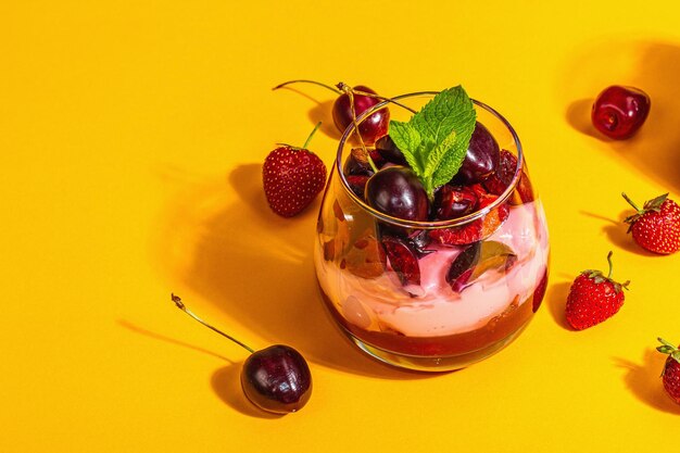 Delicious Italian dessert panna cotta with sweet cherry sauce strawberry jam fresh berries mint