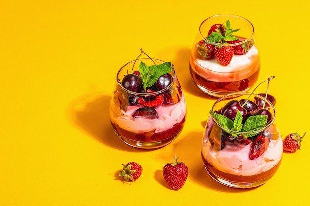 Delicious italian dessert panna cotta with sweet cherry sauce strawberry jam fresh berries mint