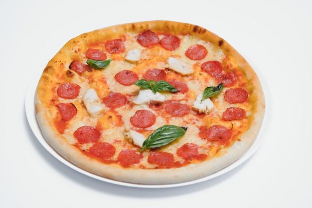 Delicious italian pizza over white background top view