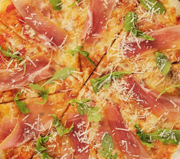 Delicious italian pizza with parma ham and rocket