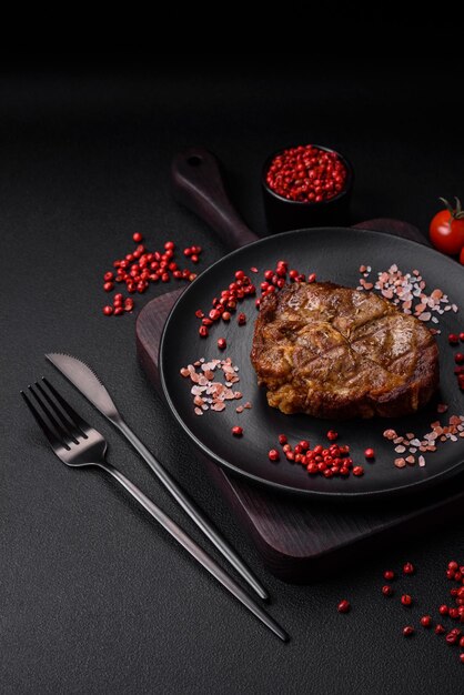 Delicious juicy pork or beef steak grilled with salt spices and herbs