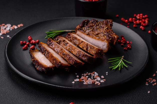 Delicious juicy pork steak on the bone with spices and herbs