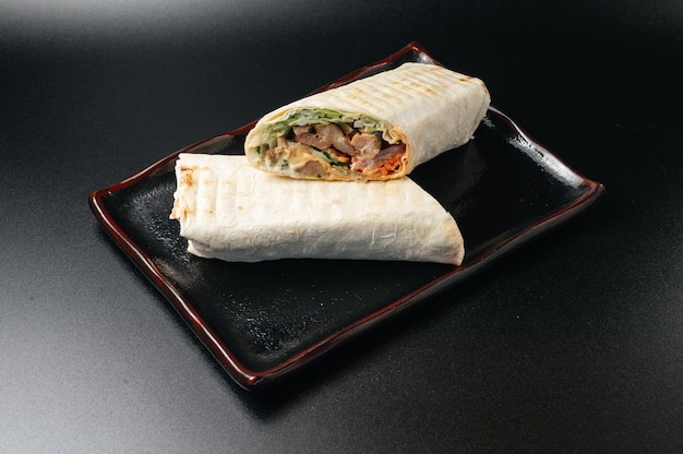 Delicious Juicy shawarma on a black surface