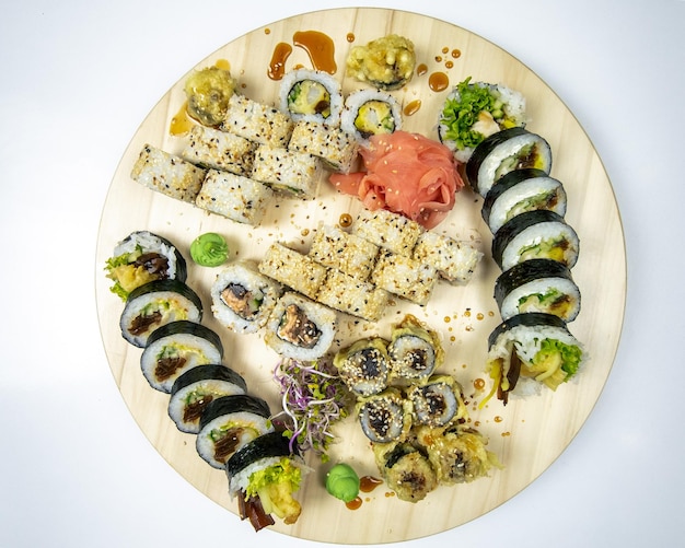 Delicious large sushi set on a round wooden board