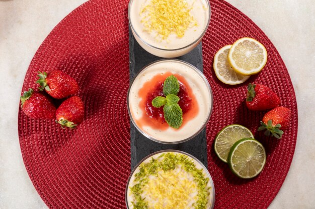 Delicious lemon mousses in glass jars on top of black stone.