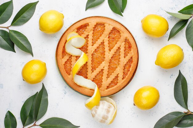 Delicious lemon pie with fresh lemons, top view