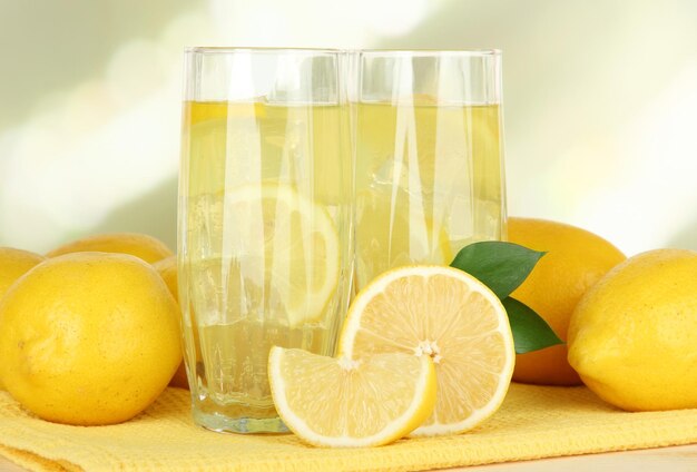 Delicious lemonade on table on light background