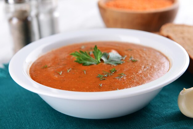 Delicious lentil creamsoup on table closeup