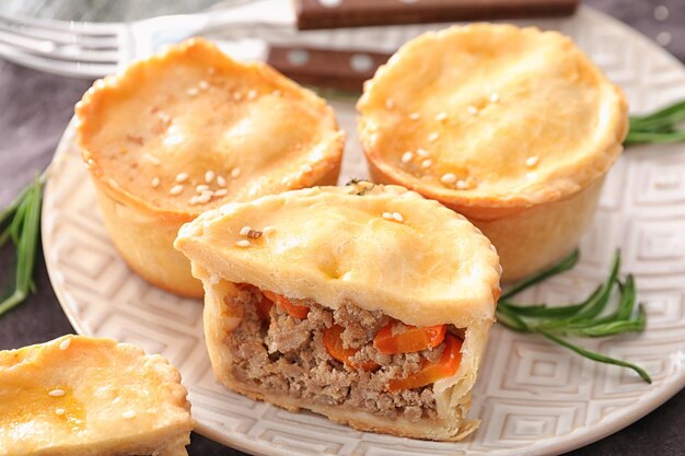 Delicious little meat pies on plate