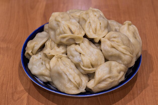 Delicious mantas on a plate on wooden background