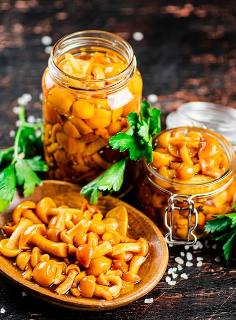 Delicious marinated mushrooms in a jar and on a plate