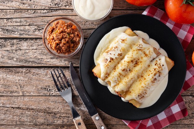 Delicious meat cannelloni pasta on rustic wooden table