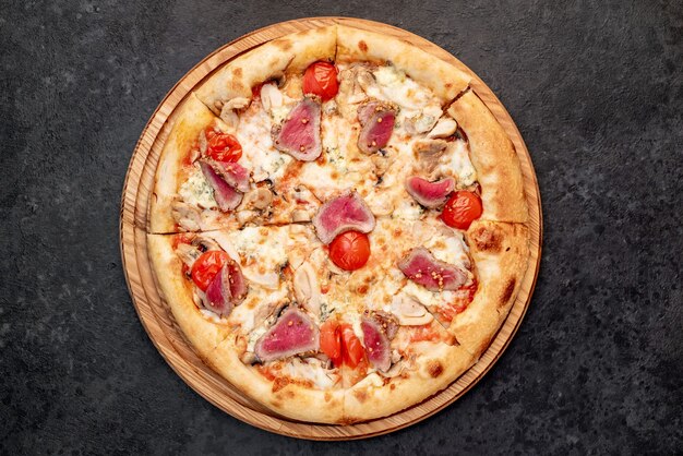 delicious meat pizza on a stone background