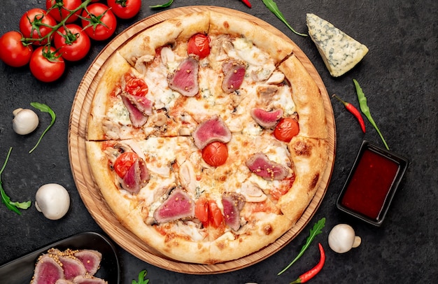 delicious meat pizza on a stone background