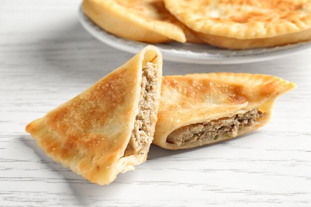 Delicious meat samosa on light background