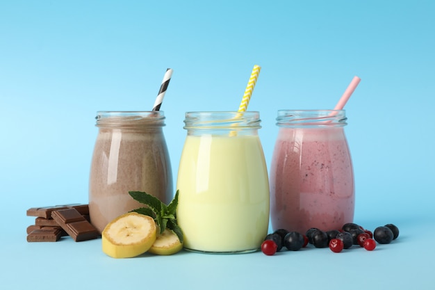 Delicious milkshakes on blue background