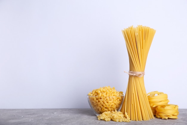 Delicious mixed pasta on a grey background