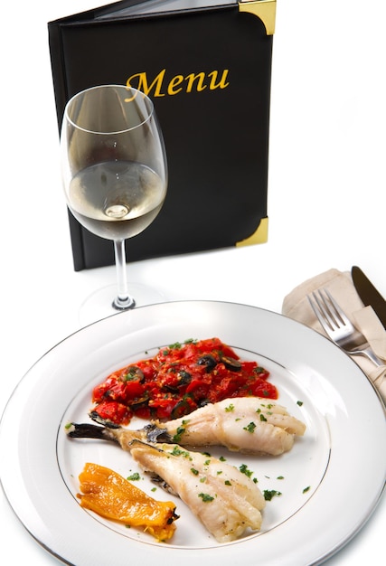 Delicious monkfish with tomatoes sauce olive and capers with menu card