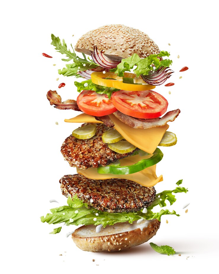 Photo delicious monster burger with flying ingredients isolated on white 
