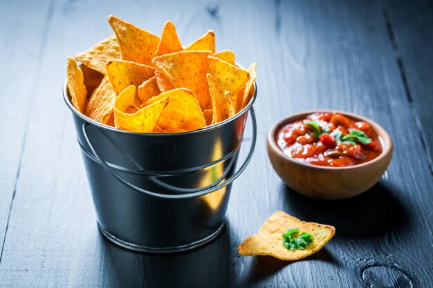 Delicious nachos with tomato dip and coriander