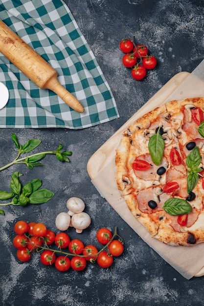 Delicious Neapolitan pizza on board with cherry tomatoes