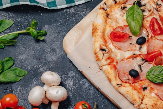 Foto deliziosa pizza napoletana a bordo con pomodorini