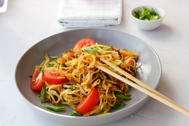 Delicious noodles in a plate with vegetables