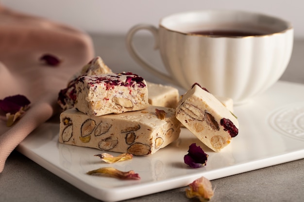 Photo delicious nougats and coffee cup still life