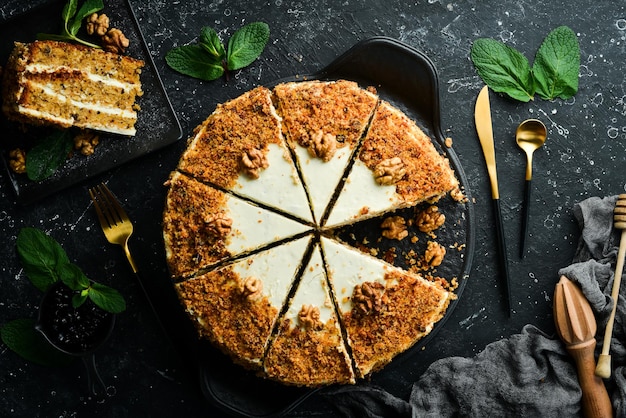 Delicious nut cake on a black stone plate Top view Rustic style