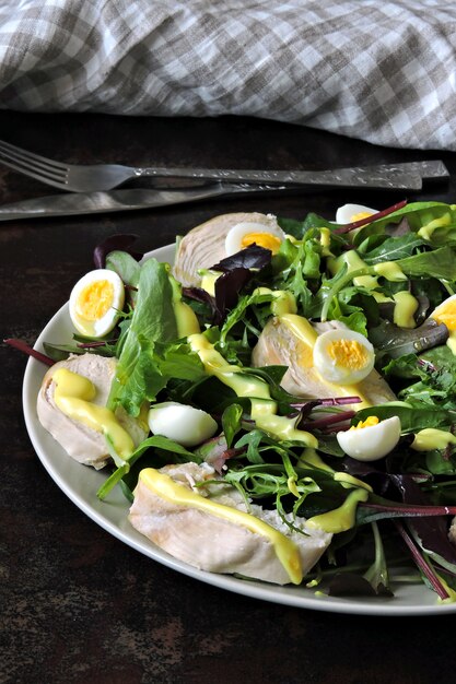 Delicious nutritious dietary salad with chicken breast and quail eggs.