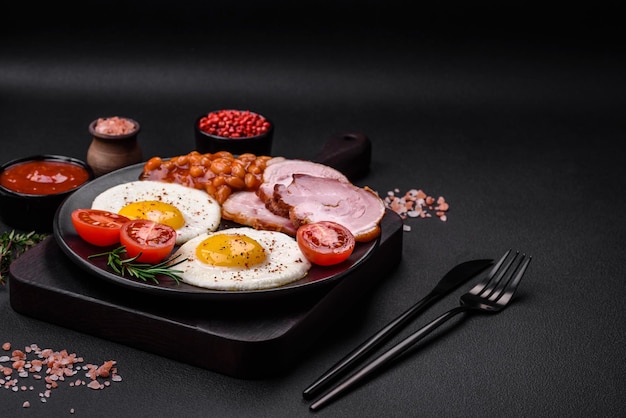 Delicious nutritious English breakfast with fried eggs and tomatoes